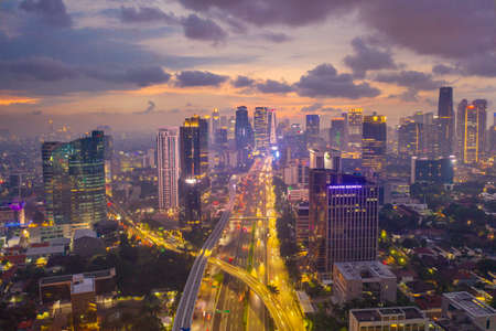 JAKARTA, Indonesia - April 29, 2020: Beautiful aerial view of Jakarta cityscape at dusk time during...