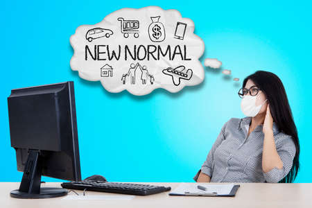 Portrait of pretty businesswoman looks confident and smiling at the camera while working in the officeの写真素材