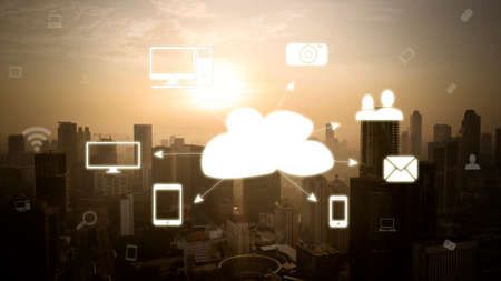 Cloud computing diagram over modern city with silhouette of skyscrapers at dusk timeの写真素材