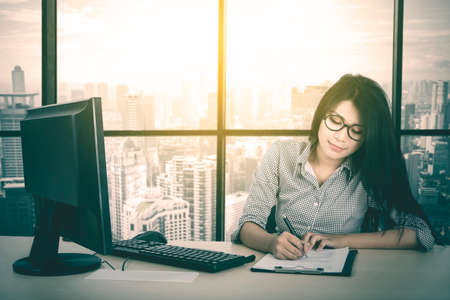 Portrait of pretty businesswoman looks confident and smiling at the camera while working in the...
