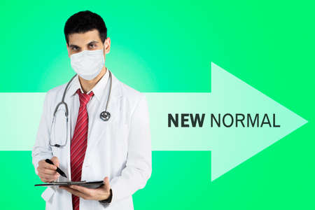 Young woman smiling at the camera while training with two dumbbells in the gym centerの写真素材