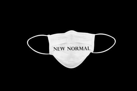 New normal text on medical protective mask with flag of Italy, isolated on black background. Symbolizing Coronavirus or Covid-19 disease in Italy.の写真素材