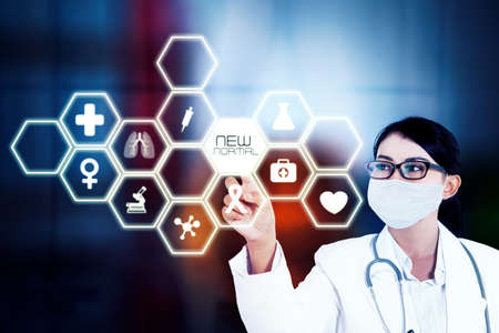 Female doctor wearing face mask while touching a button of new normal on the virtual screen