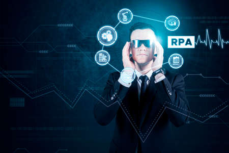 RPA system concept. Caucasian businessman working with futuristic glasses and virtual screen while...