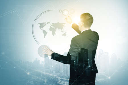 Double exposure of male manager wearing futuristic glasses while touching virtual screen and...