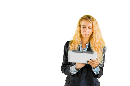 Blonde businesswoman using a digital tablet while standing with copyspace in the studio. Isolated on...