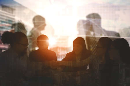 Double exposure of business people shaking hands to cooperation deal on modern cityscape backgroundの写真素材