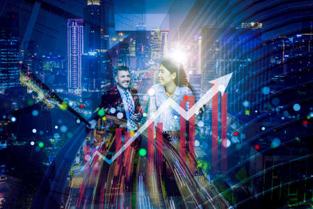 Double exposure of happy business couple talking each other while standing with upward arrow on...