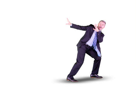 American businessman looks scared while while standing in the studio. Isolated on white backgroundの写真素材