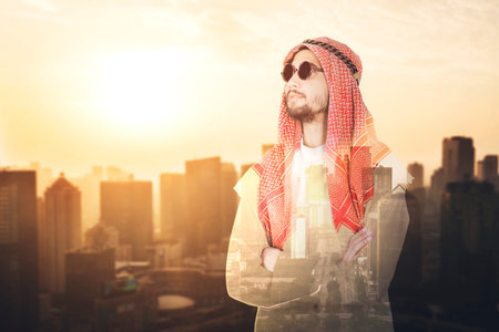 Double exposure of Arabian businessman looks confident while wearing sunglasses and standing with...