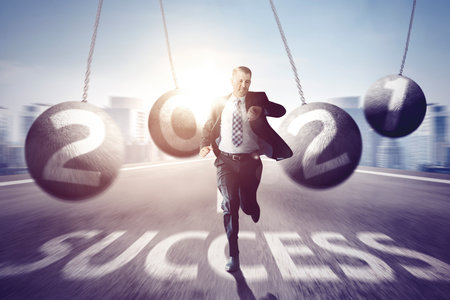 Caucasian businessman checking his watch while running on the road with success word and number 2021...
