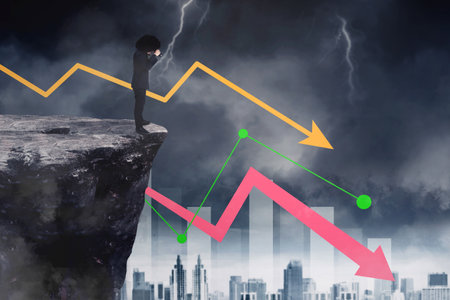 Afro businessman using binoculars to looking at declining arrow while standing on the cliff with cloudy sky backgroundの写真素材