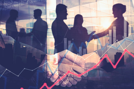 Double exposure of two businessmen shaking hands while standing with silhouette of business people and growth chart interface backgroundの写真素材