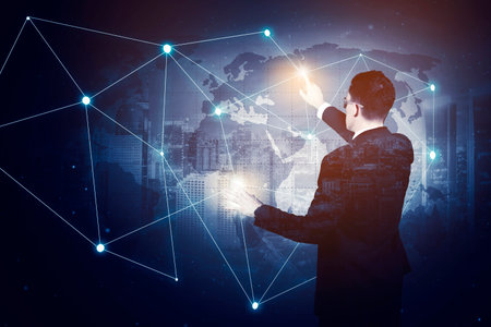 Rear view of male manager using futuristic glasses and touching network connection lines on virtual screen while standing with double exposure of modern city backgroundの写真素材