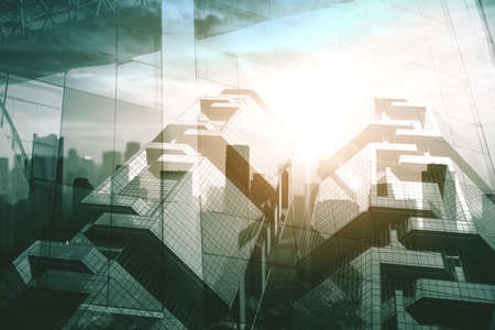 Low angle view of twin buildings with double exposure of modern city background. Shot at dusk timeの写真素材