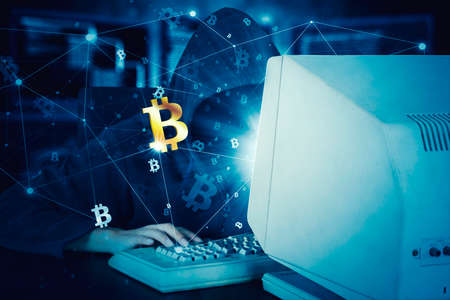 Unknown hacker using a computer to steal information with bitcoin symbol in code binary background