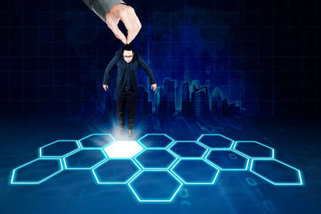 Image of recruiter hand putting a businessman on a business network with virtual screen backgroundの写真素材