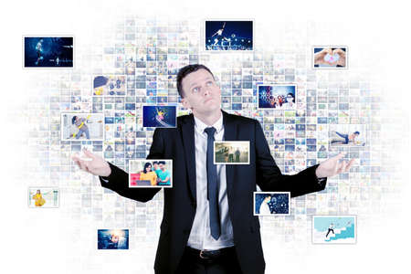 Portrait of businessman looks confused while working with pictures for advertising project in the cyberspaceの写真素材