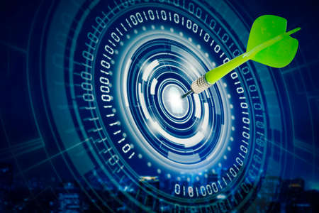 Double exposure of green darts on center of virtual screen of dartboard with cityscape backgroundの写真素材