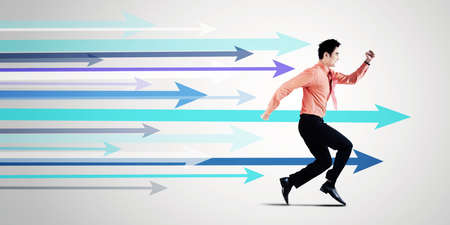 Side view of male entrepreneur running race with many arrows in the studio. Isolated on white...