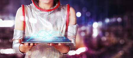 Close up of futuristic woman hands showing a digital tablet screen with connection network while standing with cityscape backgroundの写真素材