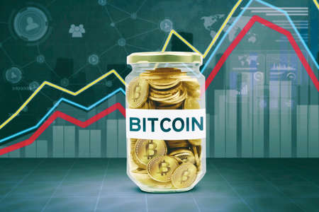 Cryptocurrency investment concept. Close up of glass jar with Bitcoin word in growth finance graph...