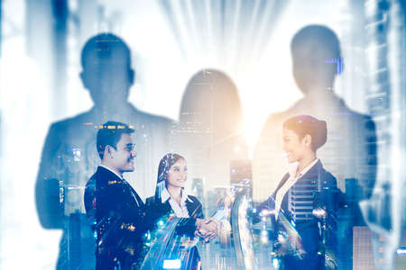 Double exposure of three business people shaking hands after business meeting with night traffic...