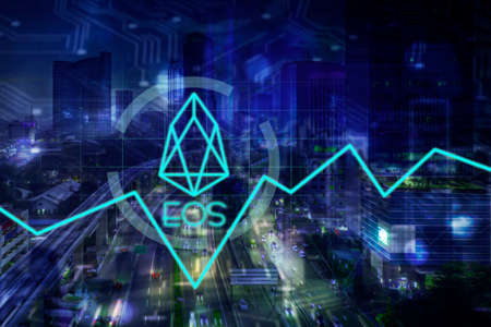 Double exposure of EOS symbol with night cityscape in virtual screen backgroundの写真素材