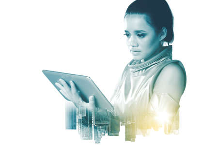 Double exposure of futuristic woman using a digital tablet while standing with modern city...