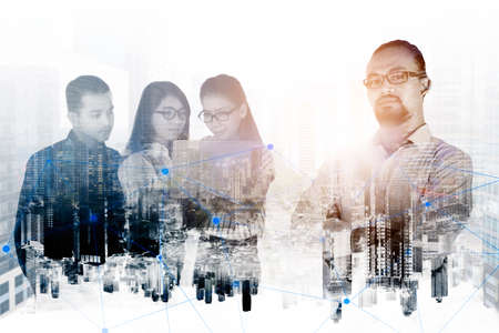 Double exposure of confident businessman standing with his employees and city modern backgroundの写真素材
