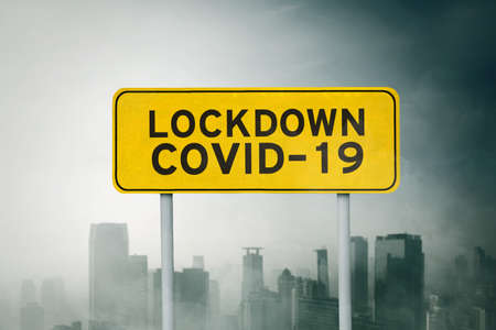 Gloomy city is lock down caused by corona virus with yellow road signの写真素材