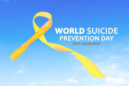 Close up of yellow ribbon with World Suicide Prevention Day text in the blue sky backgroundの写真素材