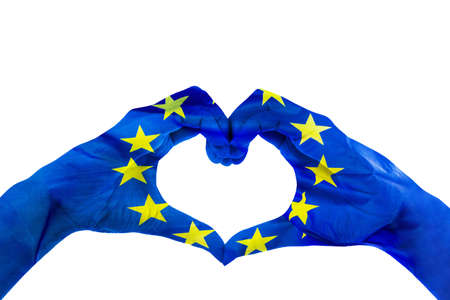 Close up of unknown hands making heart symbol patterned with European Union flag in the studio....