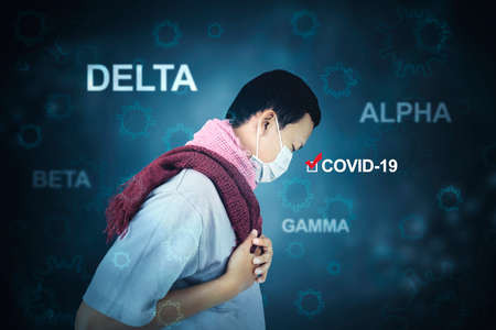 Side view of sick young man holding his chest pain while getting infected covid-19 mutation variantの写真素材