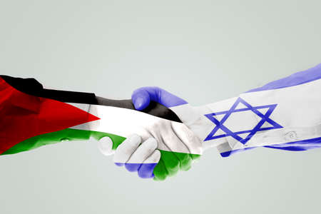Close up of two hands people handshaking each other with Israel and Palestine flagの写真素材