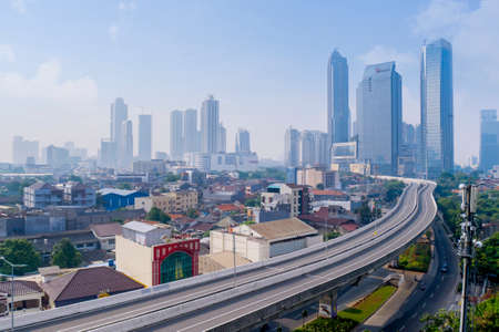JAKARTA - Indonesia. June 29, 2021: Beautiful aerial view of misty Jakarta cityscape with quiet...