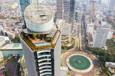 JAKARTA - Indonesia. July 27, 2021: Aerial view of quiet Hotel Indonesia Roundabout road in Jakarta city due to emergency public activity restriction (PPKM Darurat)のeditorial素材