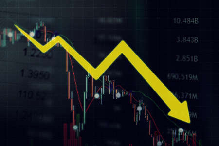 Close up of declining yellow arrow with world exchange rate backgroundの写真素材