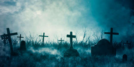 Halloween horror concept. Spooky graveyard with tombstones shaped cross symbol at misty night with full moon background. Shot in 4k resolutionの写真素材