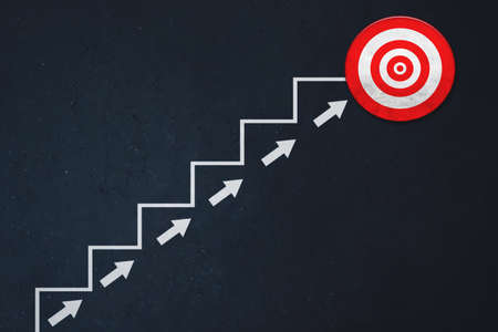 Image of empty stairs toward a red dartboard with blackboard backgroundの写真素材