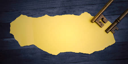 Top view of blank torn paper with two old keys on the wooden tableの写真素材