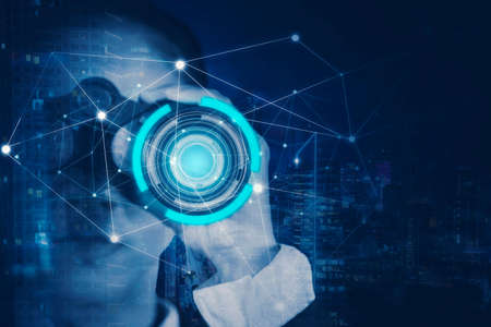 Double exposure of businesswoman using binoculars with connection network and night city backgroundの写真素材