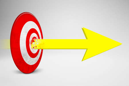 Image of yellow arrow crashing dartboard center in the studio. Isolated on white backgroundの写真素材