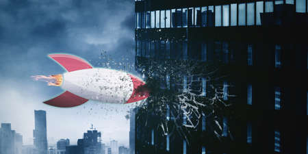 Image of startup rocket crashing a office building with cloudy sky backgroundの写真素材