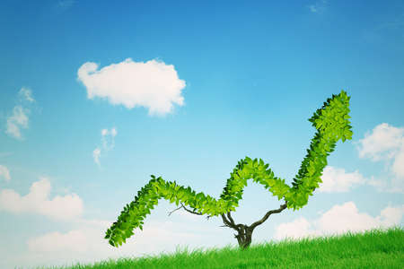 Close up of green trees shaped upward arrow with blue sky backgroundの写真素材