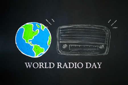 Image of earth globe and radio drawn on the blackboard with world radio day conceptの写真素材