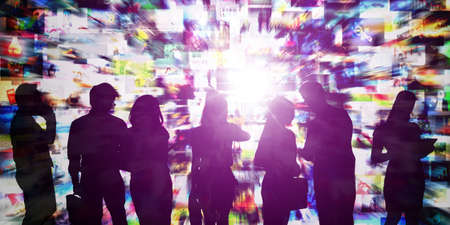 Silhouette of business people working in metaverse with blurred lights backgroundの写真素材