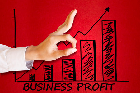 Close up of businessman flicking an arrow to changing upward direction with increasing business profit chartの写真素材
