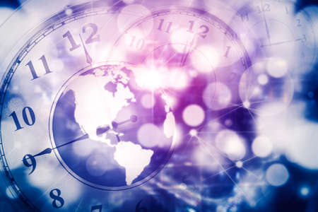 Double exposure of earth globe and clock in the cyberspace with blurred sparkling light backgroundの写真素材