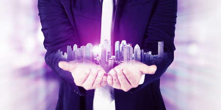 Close up of male manager hands showing modern cityscape while standing in the metaverseの写真素材